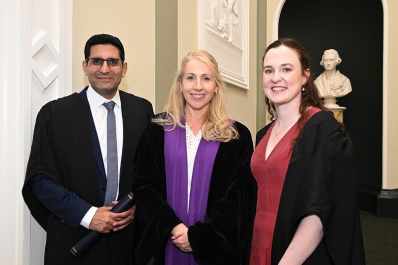 Dr Emer Kelly, IOM with two CSCST graduates on staircase at No. 6 Kildare Street, Dublin